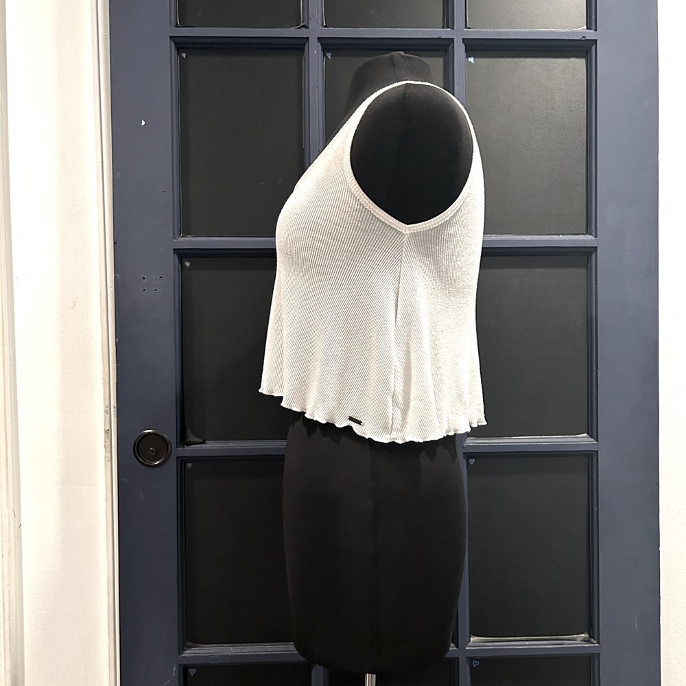 Flowy white tank with lettuce hem.